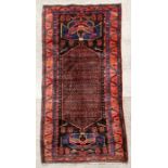 A Persian Kordi woollen hand knotted runner with stylised birds within a geometric border, on a