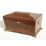 A Regency figured mahogany sarcophagus form tea caddy with two internal lidded caddies, cut glass