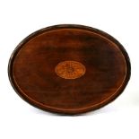 A Georgian mahogany oval galleried tray with central inlaid stylised sun, 46cms (18ins) wide.