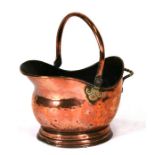 A Victorian copper and brass coal scuttle, 38.5cms (18ins) long.