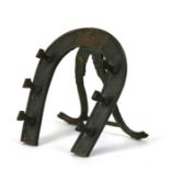 A Victorian novelty brass horse shoe shaped desk top pen stand by 'Perry & Co' with lozenge mark