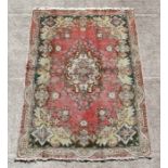 A Persian Tabriz woollen hand knotted rug with floral design on a beige ground, 185 by 135cms (73 by