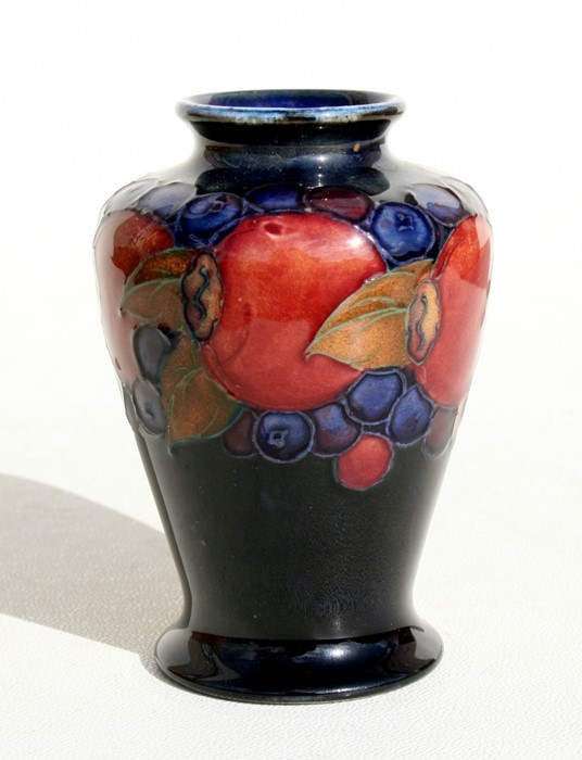 A Moorcroft vase decorated with fruit, 9cms (3.5ins) high.Condition Report Crazing to glaze,