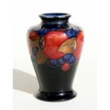 A Moorcroft vase decorated with fruit, 9cms (3.5ins) high.Condition Report Crazing to glaze,