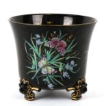 A Victorian jardiniere decorated with butterflies on a black ground, 17cms (6.75ins) high.