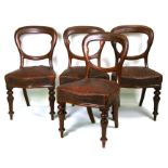 A set of four Victorian mahogany balloon back dining chairs with upholstered seat on turned front