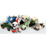 A group of painted tin models to include Vespa's, a tractor and a motor vehicle, the largest