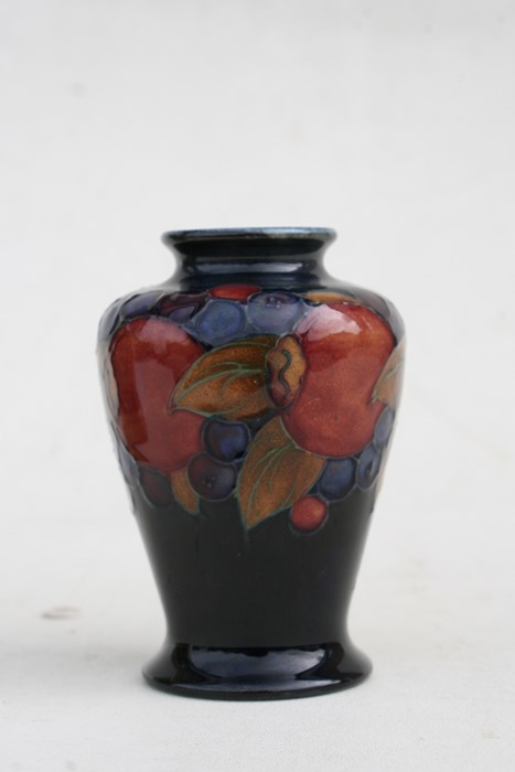 A Moorcroft vase decorated with fruit, 9cms (3.5ins) high.Condition Report Crazing to glaze, - Image 3 of 7