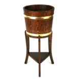 An early 20th century brass bound oak jardiniere, 31cms (12.25ins) diameter.