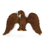 A 19th century carved pine eagle with out swept wings, 48cms (18.75ins) wide.