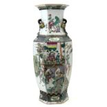 A Chinese famille verte vase of hexagonal form, decorated with figures in a court scene, 60cms (23.