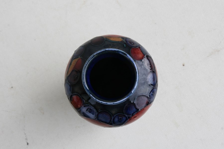 A Moorcroft vase decorated with fruit, 9cms (3.5ins) high.Condition Report Crazing to glaze, - Image 7 of 7