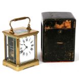 A French brass cased carriage clock, the white enamel dial with Roman numerals, the movement