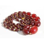 A cherry amber Bakelite bead necklace, the largest bead 16mm wide.