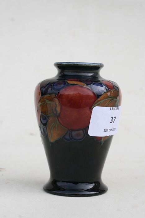 A Moorcroft vase decorated with fruit, 9cms (3.5ins) high.Condition Report Crazing to glaze, - Image 4 of 7