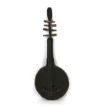 An African leather and carved wood stringed instrument, 59cms (23ins) high.
