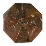 An octagonal marble stand with fossil inclusions, 30cms (12ins) diameter.