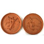 A pair of 19th century terracotta classical relief moulded circular plaques, with impressed mark for