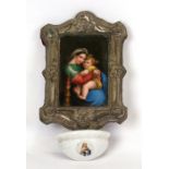 A 19th century continental porcelain plaque depicting a mother and child, in a silver plated frame