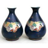 A Japanese porcelain sake set to include two bottles and four cups; together with a pair of Japanese