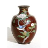 A Japanese cloisonne vase decorated with bird perched in flowering foliage, on a gold flecked