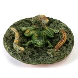 A 19th century Portuguese Palissy ware wall plate decorated with a frog, two caterpillars and a