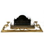 A cast iron fire grate; together with two brass fenders, the largest 132cms (52ins) wide.