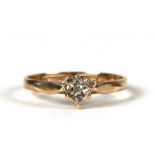 A 9ct gold diamond ring set in a heart shaped mount, approx UK size 'M'.