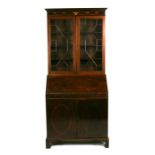 An Edwardian inlaid mahogany bureau bookcase, the pair of astragal glazed doors enclosing a