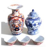 Three 20th century Chinese famille rose bowls; a Japanese Imari vase; and a Chinese blue & white