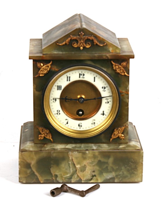 A Victorian mantle clock, the white enamel dial with Arabic numerals, in a figured green marble case