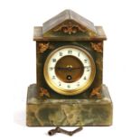 A Victorian mantle clock, the white enamel dial with Arabic numerals, in a figured green marble case