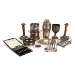 A quantity of silver plated items to include toast racks, goblet, cocktail shaker, wine coaster