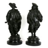 A pair of bronzed spelter figures in the form of cavaliers, on ebonised wooden plinths, 53cms (