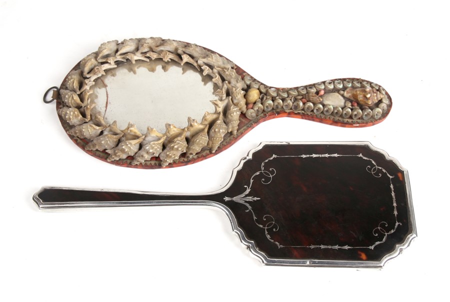 A silver and tortoiseshell hand mirror, Birmingham 1929, 28cms (11ins) long; together with a