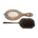 A silver and tortoiseshell hand mirror, Birmingham 1929, 28cms (11ins) long; together with a