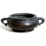 A Chinese bronze two-handled censer with nine character mark to underside, 14cms (5.5ins) wide.