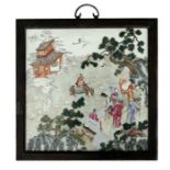 A large Chinese famille rose square porcelain plaque decorated with figures in a landscape, in a