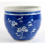 A late 19th / early 20th century Chinese blue & white jardiniere decorated with prunus, 21cms (8.