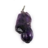 An antique Chinese carved amethyst pendant in the form of a gourd, with a diamond set suspension