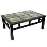 A Chinese hardwood low table with six inset slate panels, 129cms (51ins) wide.