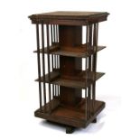 An early 20th century oak revolving bookcase, 58cms (23ins) wide.