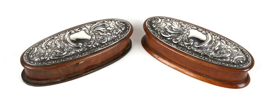 A pair of Edwardian oval mahogany silver mounted trinket boxes, Chester 1907, 15cms (6ins) wide.