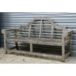 A large well weathered teak Lutyens style garden bench, 196cms (77ins) wide.