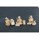 A pair of late 19th century Japanese ivory okimonos depicting craftsmen working, 4cms (1.5ins)