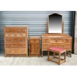 A Heals style limed oak bedroom suite comprising a wardrobe, chest, dressing table, bedside