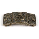 A 19th century Qing bronze two-piece Chinese buckle decorated with dragons, 7cms (2.75ins) wide.