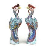 A pair of Chinese famille rose phoenix figures with impressed mark to underside, 17cms (6.75ins)