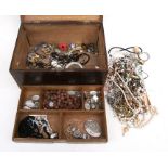 A quantity of costume jewellery in an oak jewellery box.