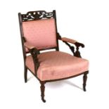 A late 19th century mahogany armchair with upholstered seat and back, on turned front supports,